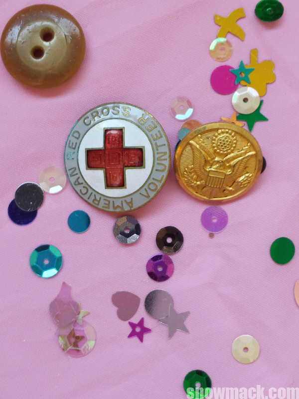 While working on the Compassion series, I found my Mother Mary's WWII American Red Cross Volunteer pin and one of my Father Jerry's Army uniform buttons in a bag of her buttons.  Mary saved buttons and other sewing essentials throughout her lifetime .  